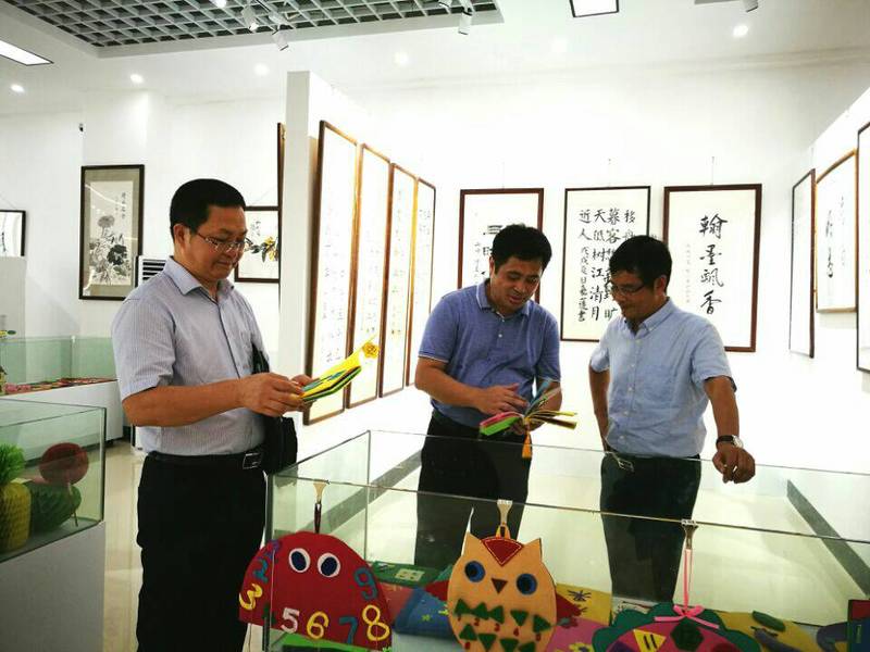 2018年9月10日学校党委陈锦山副书记（右）参观beat365中国在线体育第一届师生书画作品展。